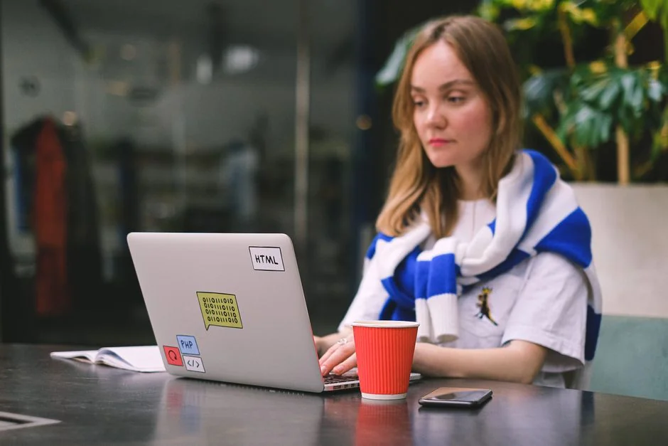 A sleek workspace with a laptop and monitors showing design software in use.